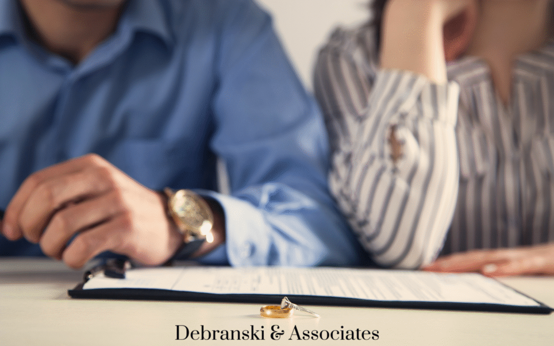 Man and woman signing divorce paperwork at law office